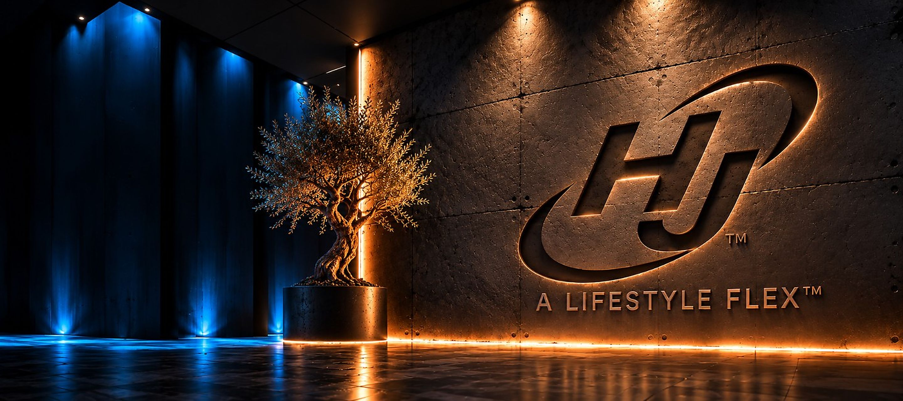 HJ logo and A Lifestyle Flex lettering lit on a concrete wall beside an olive tree